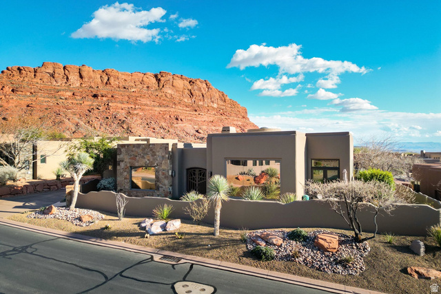 3052 Snow Canyon Parkway, Unit 66 St. George, UT 84770 - Photo 1 of 1 Pueblo-style house with stucco siding and stone siding