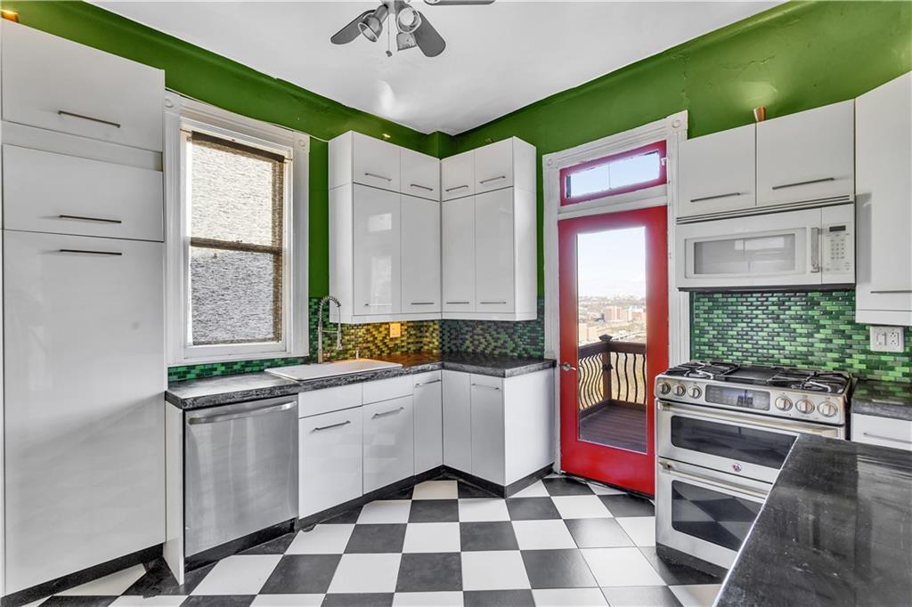 85 Wyoming Street Pittsburgh, PA 15211 - Photo 13 of 33 a kitchen with a sink window and cabinets