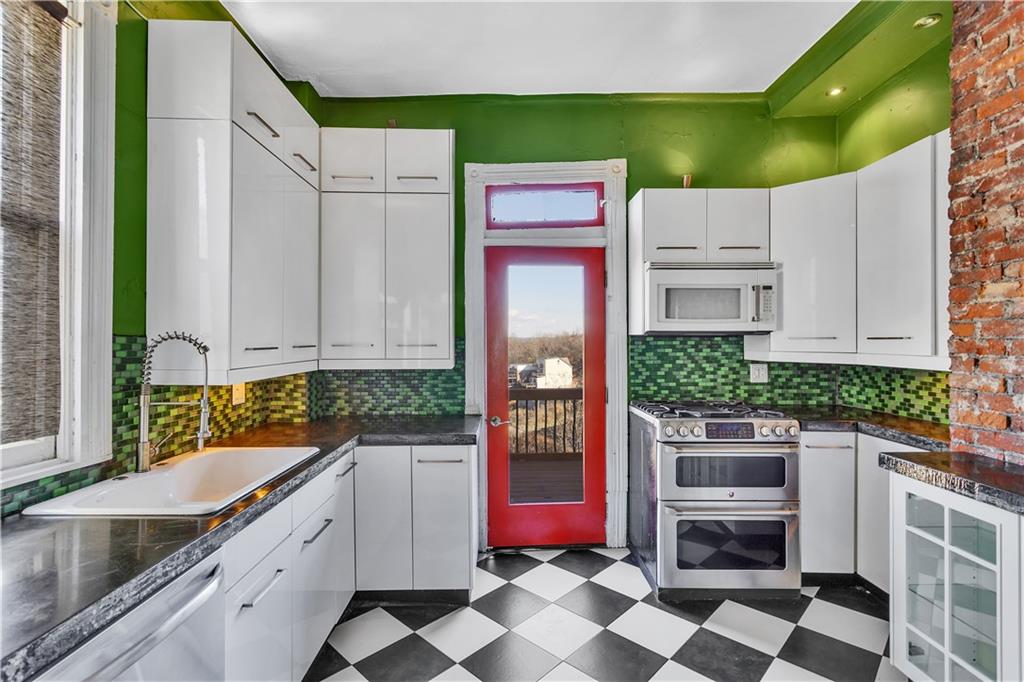 85 Wyoming Street Pittsburgh, PA 15211 - Photo 14 of 33 a kitchen that has a cabinets and a stove