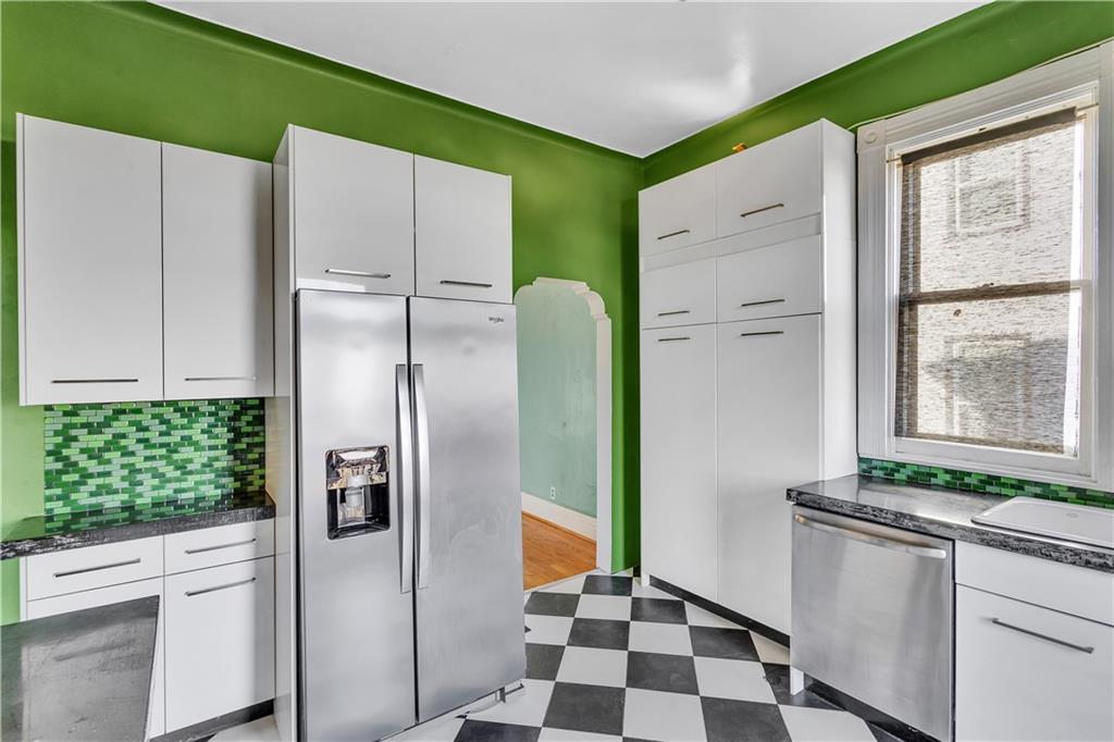 85 Wyoming Street Pittsburgh, PA 15211 - Photo 15 of 33 a kitchen with stainless steel appliances granite countertop a refrigerator and a stove