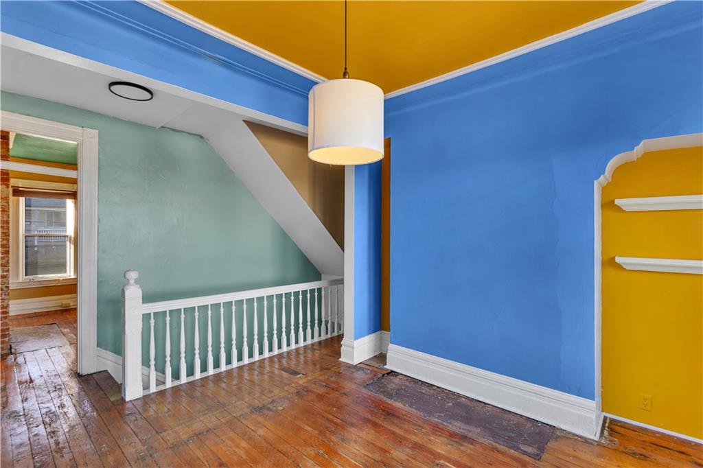 85 Wyoming Street Pittsburgh, PA 15211 - Photo 17 of 33 a view of a hallway with wooden floor