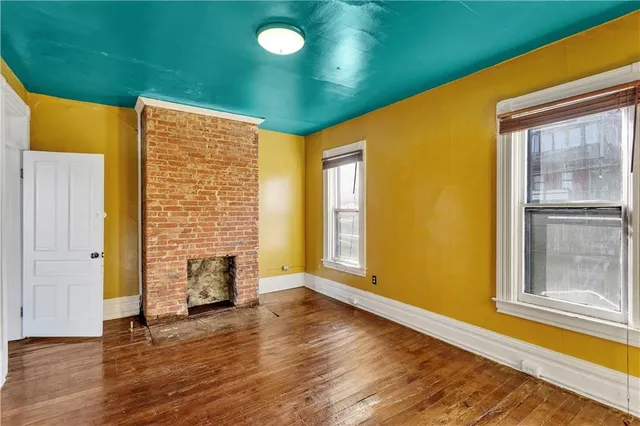 a view of livingroom with wooden floor and front door