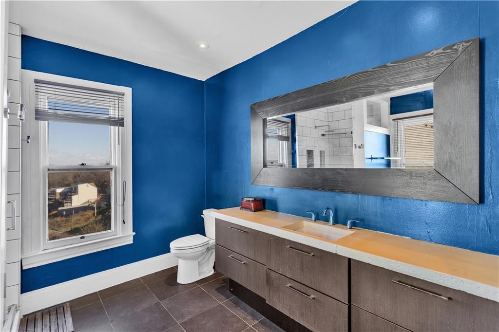 85 Wyoming Street Pittsburgh, PA 15211 - Photo 22 of 33 a bathroom with a toilet a sink and mirror