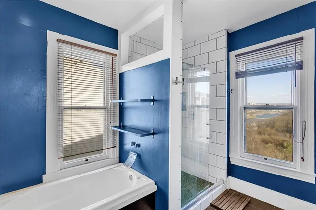 a bathroom with a bathtub and a shower
