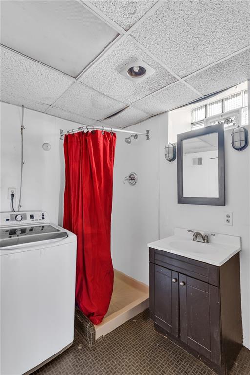 85 Wyoming Street Pittsburgh, PA 15211 - Photo 29 of 33 a bathroom with a sink a mirror and a shower