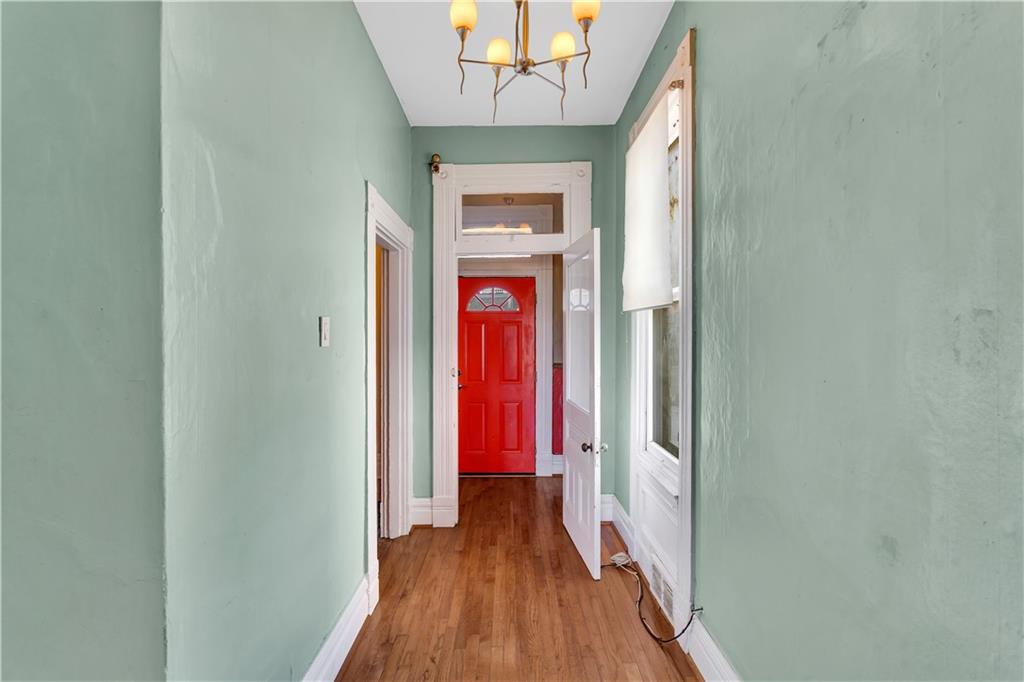 85 Wyoming Street Pittsburgh, PA 15211 - Photo 4 of 33 a view of a hallway with wooden floor and staircase