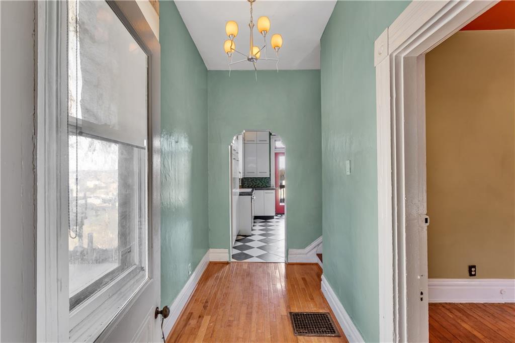 85 Wyoming Street Pittsburgh, PA 15211 - Photo 5 of 33 a view of a hallway with wooden floor and a bathroom