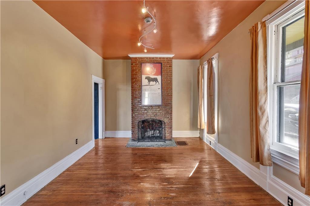 85 Wyoming Street Pittsburgh, PA 15211 - Photo 6 of 33 a view of an empty room with fireplace and windows