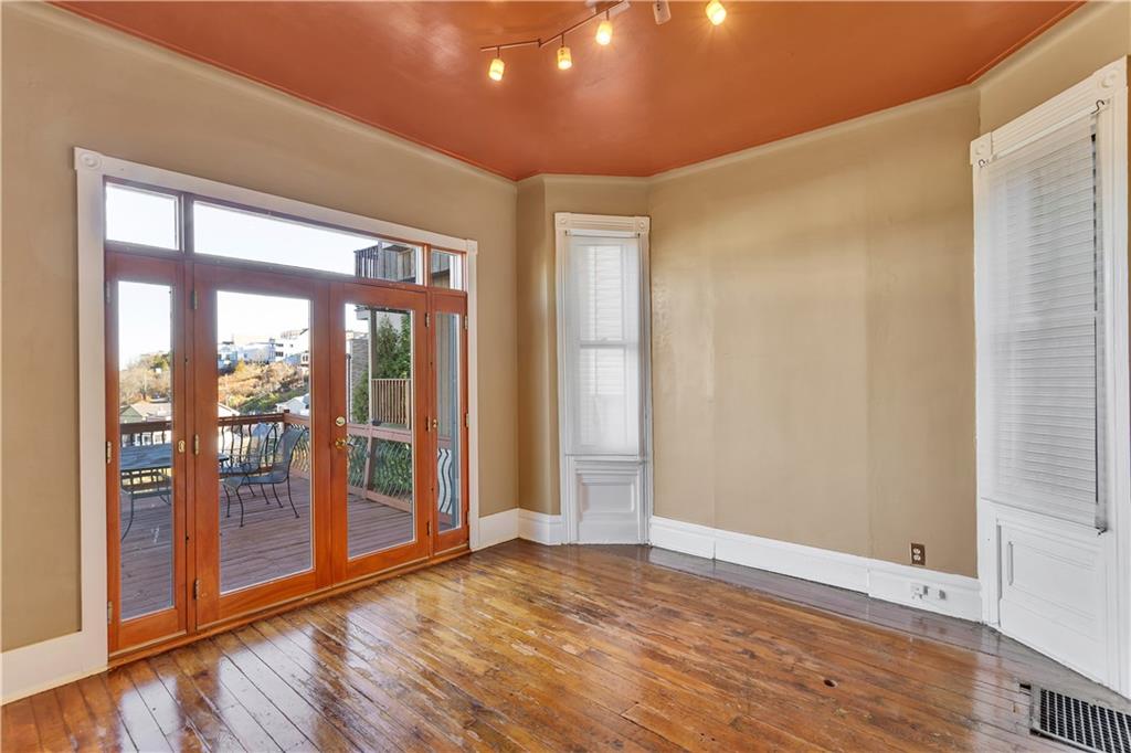 85 Wyoming Street Pittsburgh, PA 15211 - Photo 9 of 33 a view of an empty room with wooden floor and a window