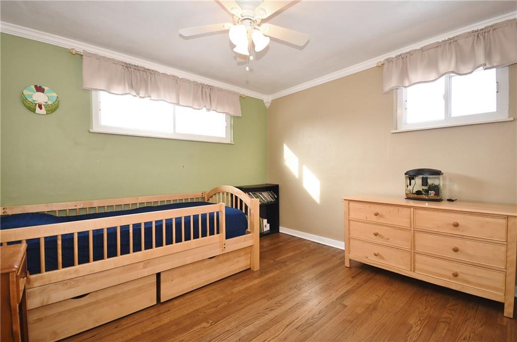 200 West Bruceton Road Pittsburgh, PA 15236 - Photo 15 of 25 Bedroom 3 features hardwood floor, neutral painted walls, and a paddle fan. A spacious closet is also included.