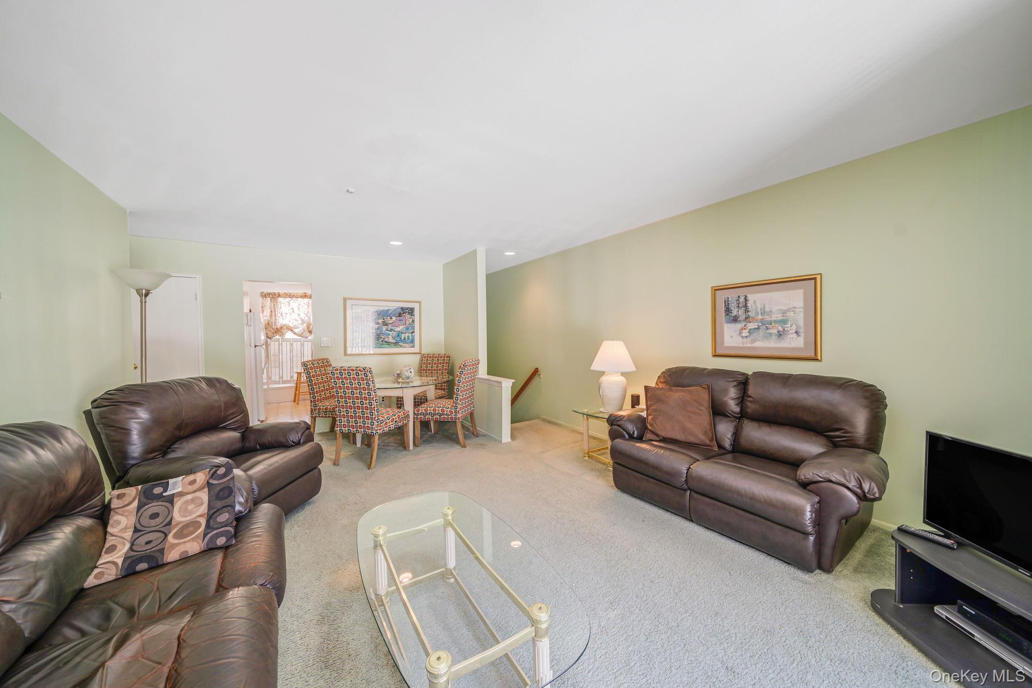 8 Juniper Court, Unit 8 Selden, NY 11784 - Photo 2 of 14 Living room featuring light colored carpet and recessed lighting