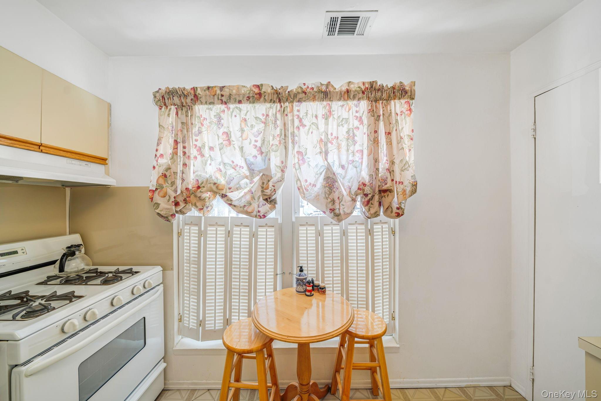 8 Juniper Court, Unit 8 Selden, NY 11784 - Photo 5 of 14 Kitchen featuring white gas range oven and light countertops