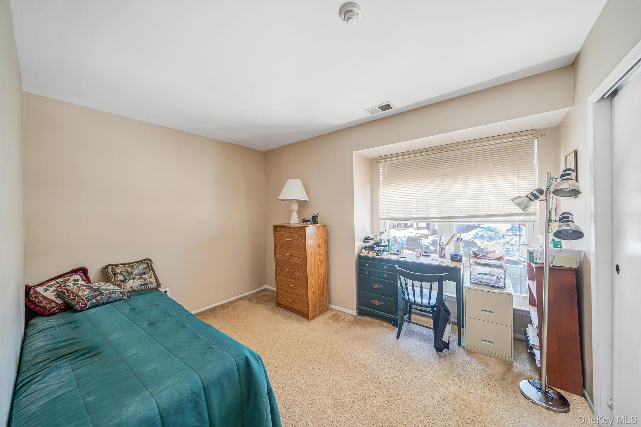 8 Juniper Court, Unit 8 Selden, NY 11784 - Photo 7 of 14 Bedroom featuring light carpet and a desk