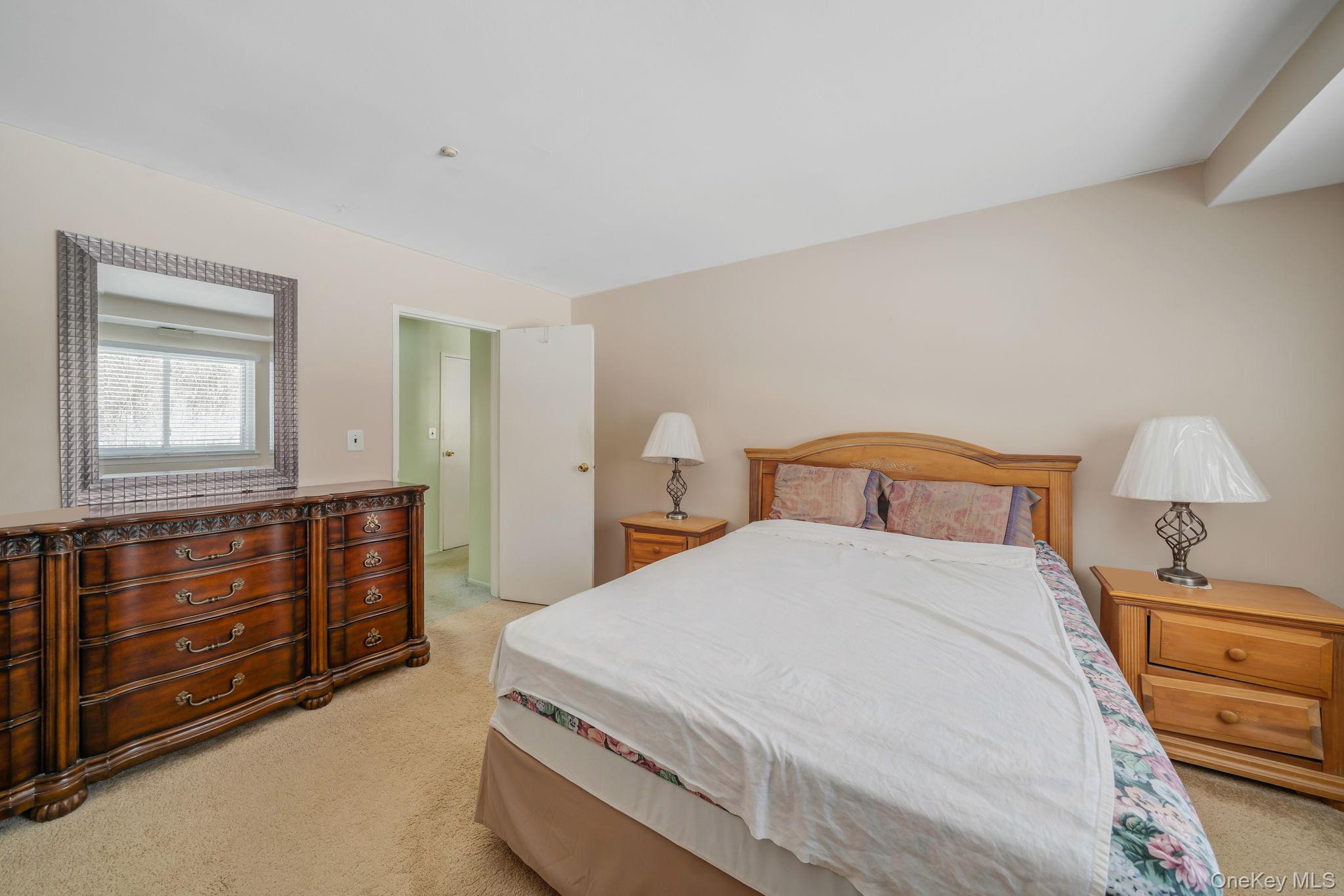 8 Juniper Court, Unit 8 Selden, NY 11784 - Photo 9 of 14 Bedroom featuring light carpet