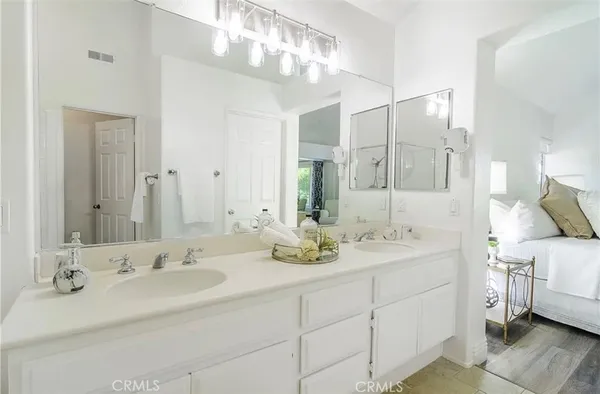 a bathroom with a double vanity sink mirror and