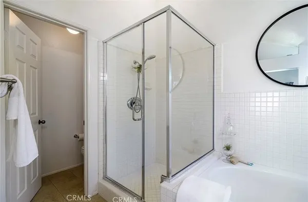 a bathroom with a mirror and a glass shower door