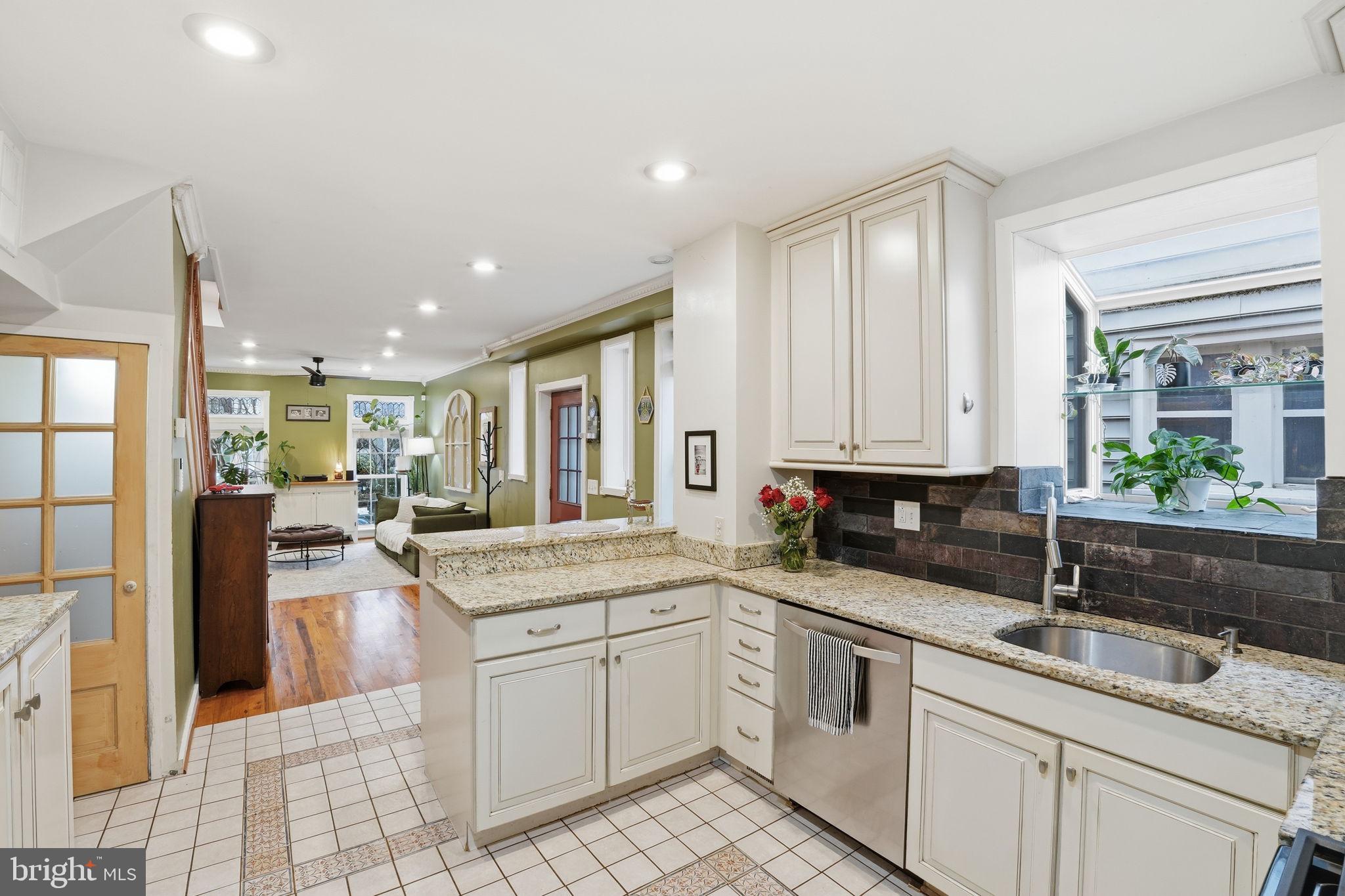 1616 D Street Southeast Washington, DC 20003 - Photo 10 of 37 a kitchen with a sink stove and cabinets