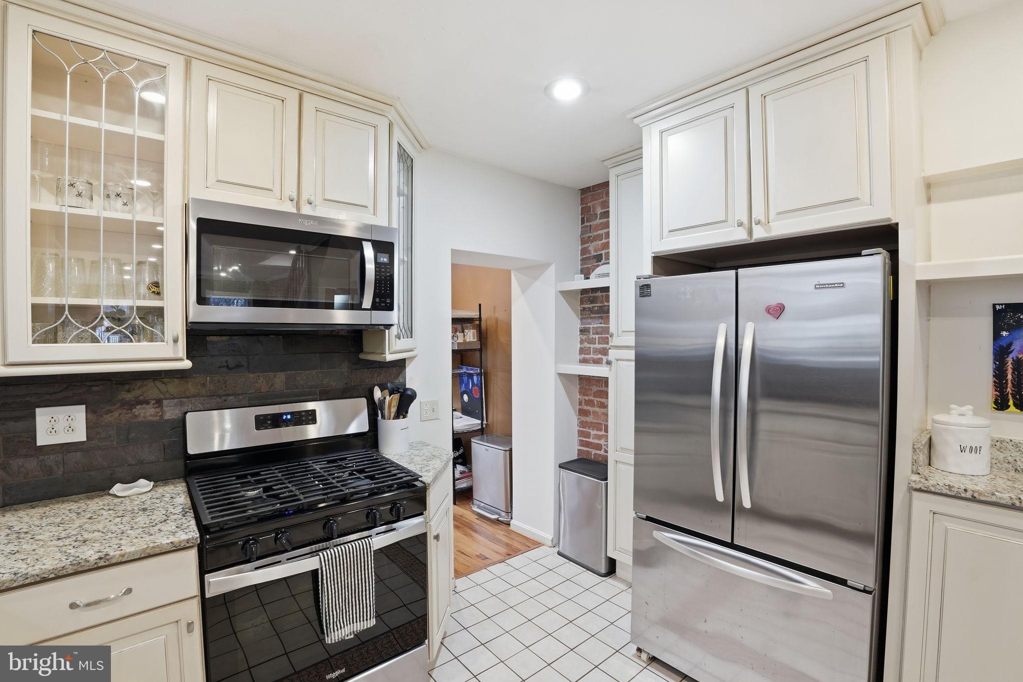 1616 D Street Southeast Washington, DC 20003 - Photo 11 of 37 a kitchen with stainless steel appliances granite countertop a stove a refrigerator and a granite counter tops