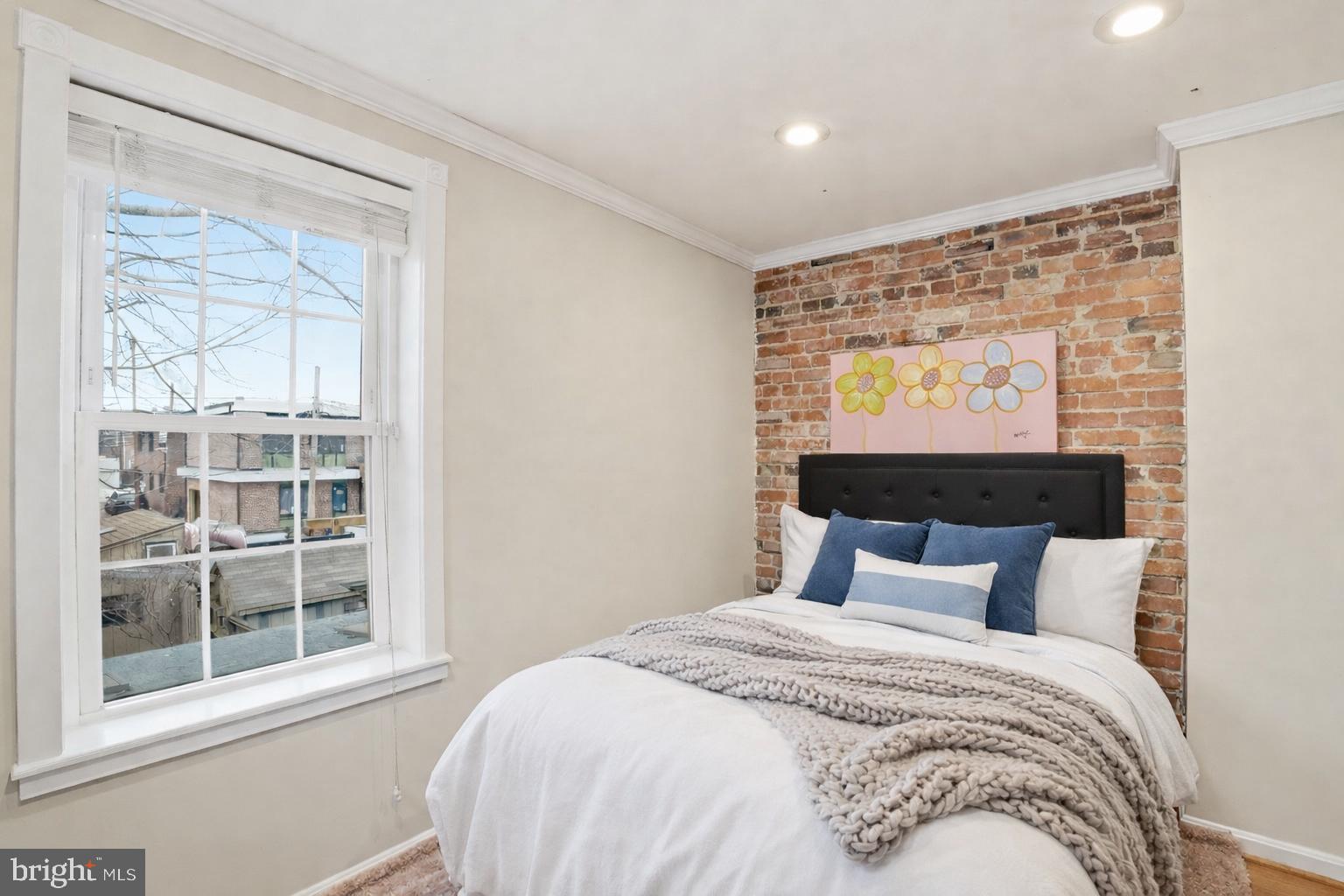 1616 D Street Southeast Washington, DC 20003 - Photo 22 of 37 a bedroom with a large bed and a window