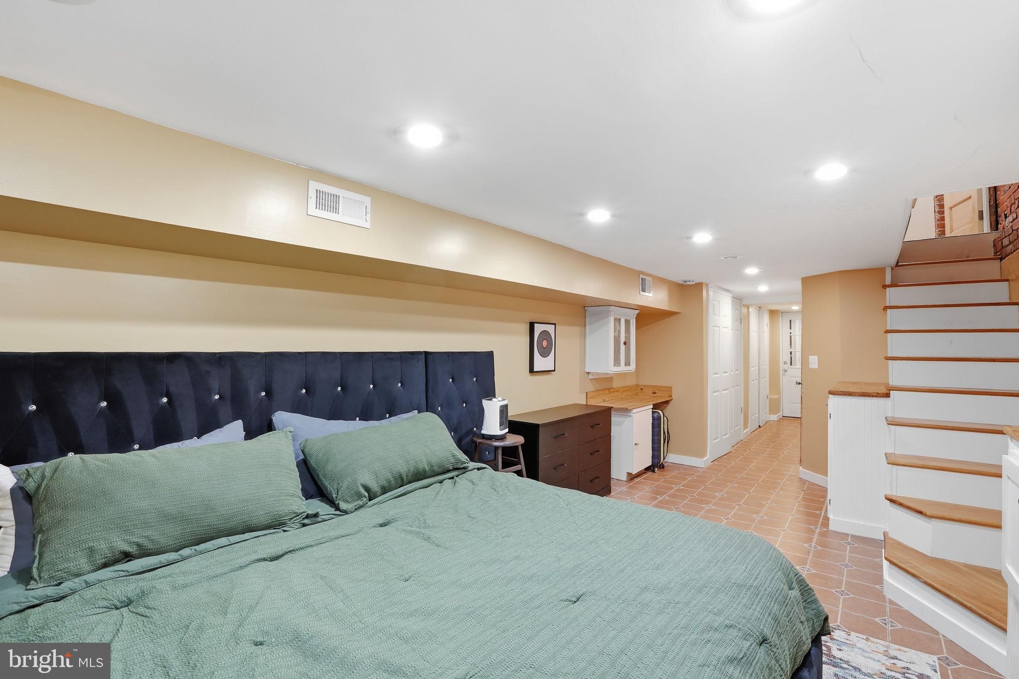 1616 D Street Southeast Washington, DC 20003 - Photo 24 of 37 a spacious bedroom with a large bed and a dresser