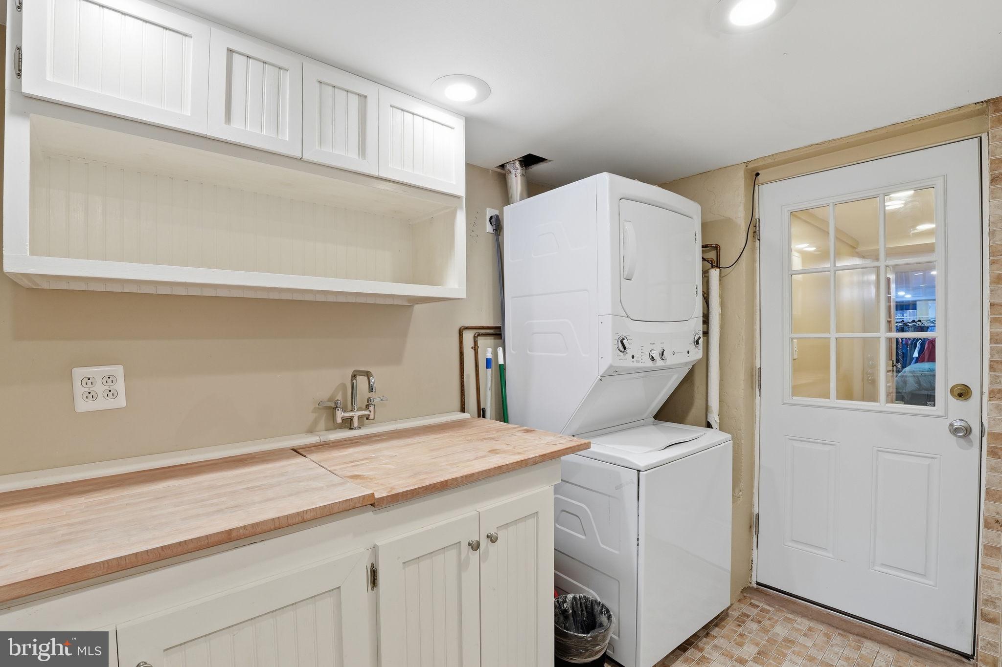 1616 D Street Southeast Washington, DC 20003 - Photo 28 of 37 a bathroom with a granite countertop sink and washing machine