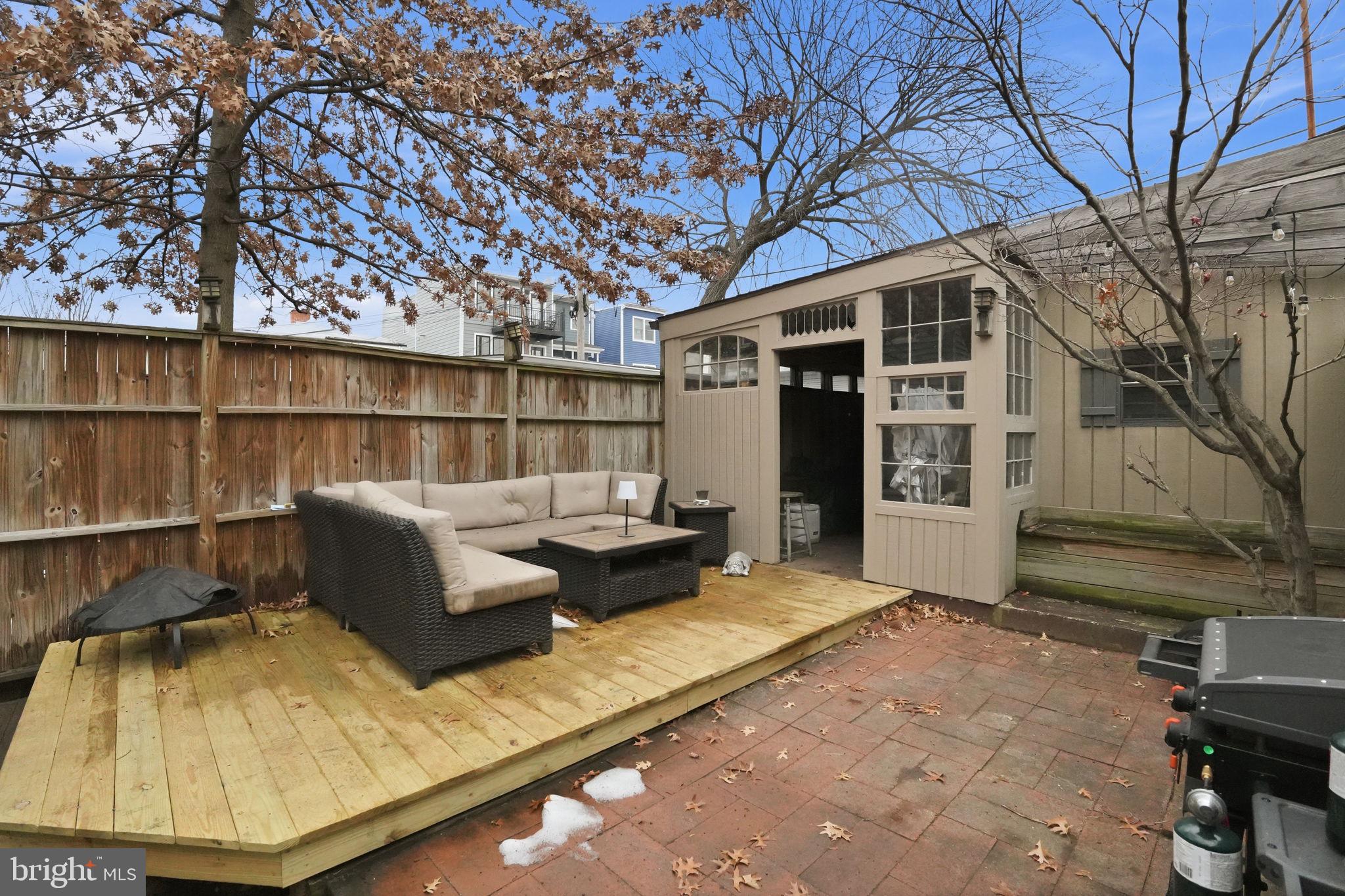 1616 D Street Southeast Washington, DC 20003 - Photo 29 of 37 a backyard of a house with barbeque oven and outdoor seating