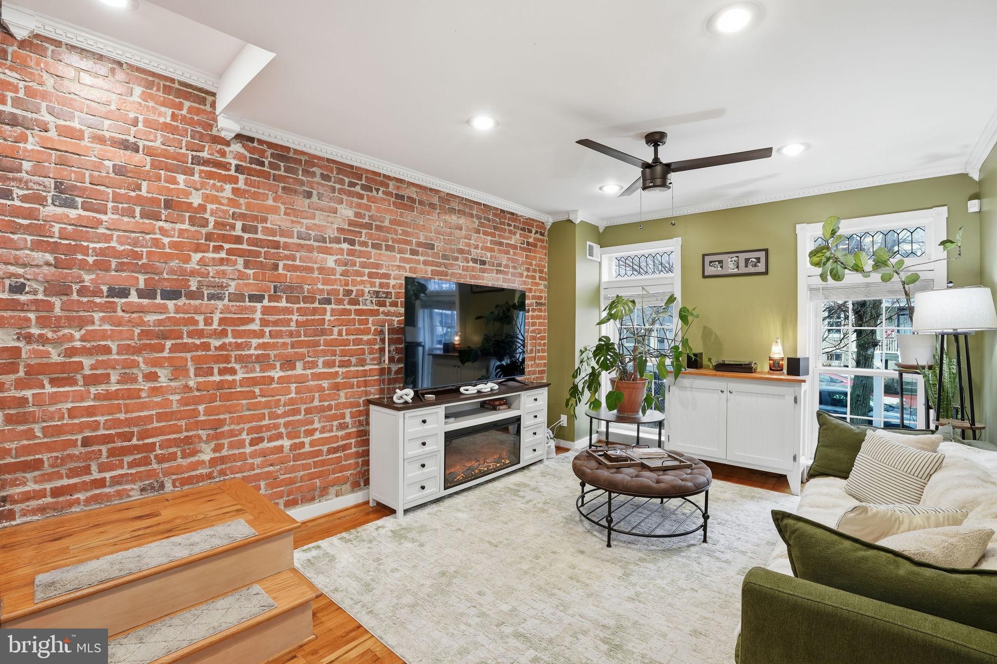 1616 D Street Southeast Washington, DC 20003 - Photo 2 of 37 a living room with furniture and a flat screen tv