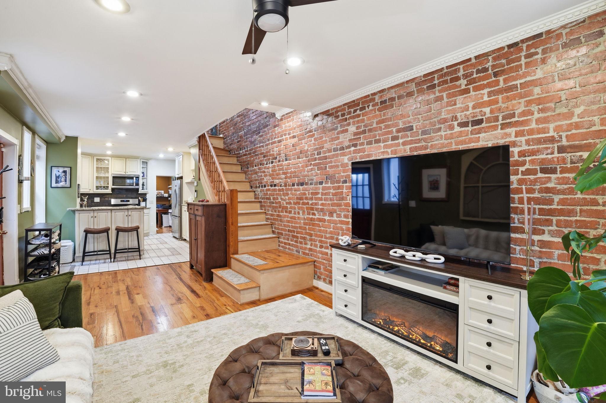 1616 D Street Southeast Washington, DC 20003 - Photo 4 of 37 a living room with furniture and a fireplace