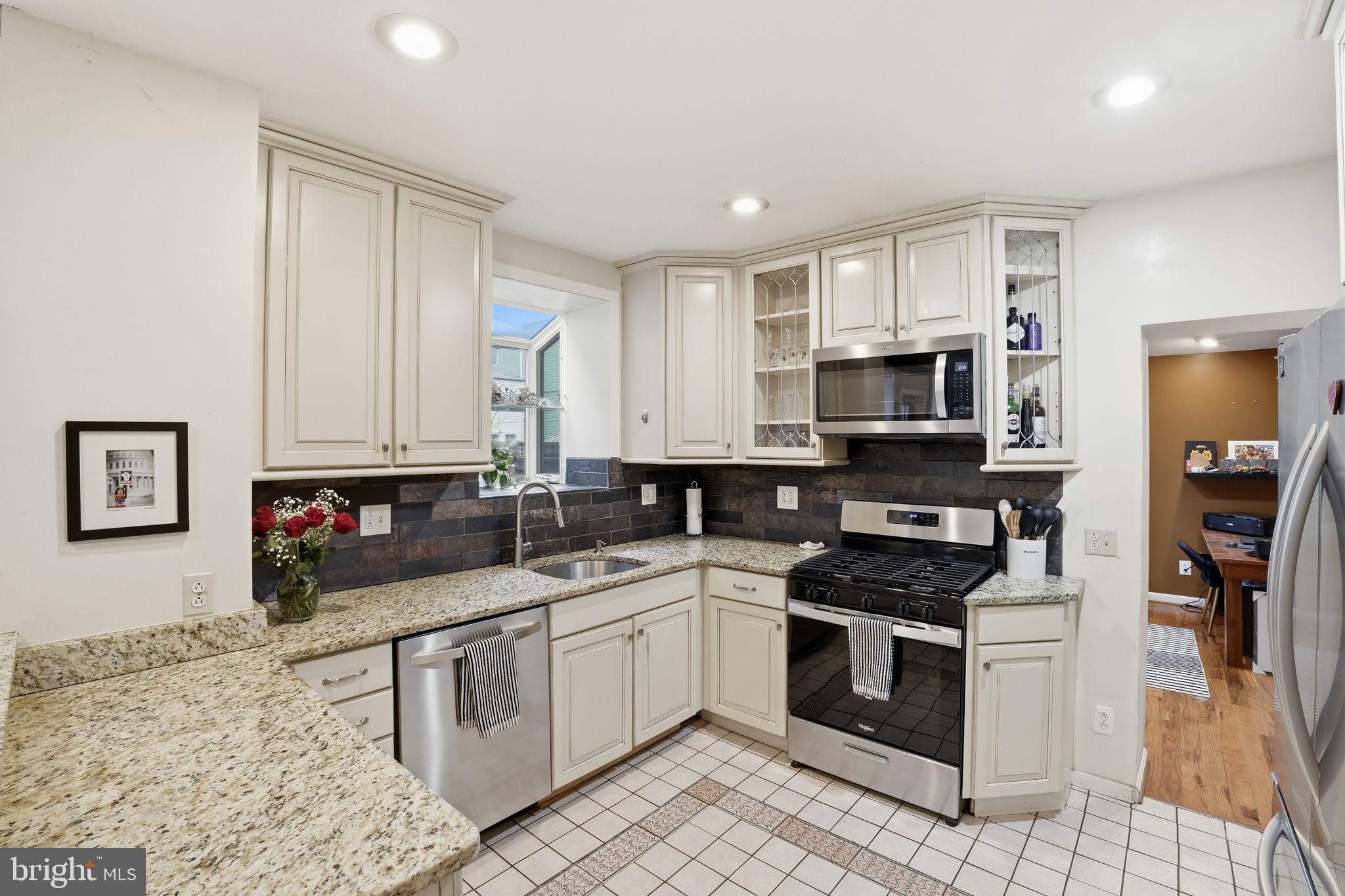 1616 D Street Southeast Washington, DC 20003 - Photo 9 of 37 a kitchen with stainless steel appliances granite countertop a stove a sink dishwasher and a microwave