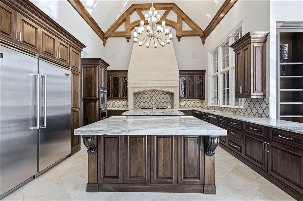 2957 Darlington Run Duluth, GA 30097 - Photo 17 of 58 a kitchen with a stove a refrigerator and a chandelier