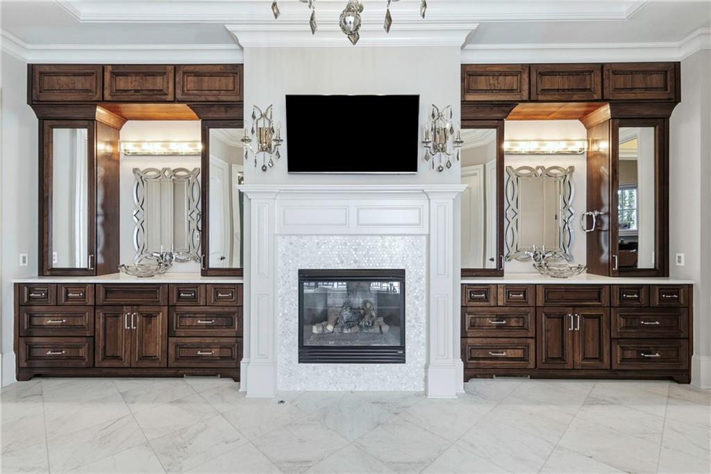 2957 Darlington Run Duluth, GA 30097 - Photo 30 of 58 a living room with furniture a flat screen tv and a fireplace