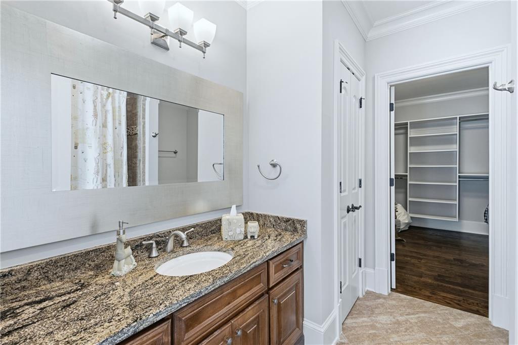 2957 Darlington Run Duluth, GA 30097 - Photo 44 of 58 a bathroom with a granite countertop sink and a mirror
