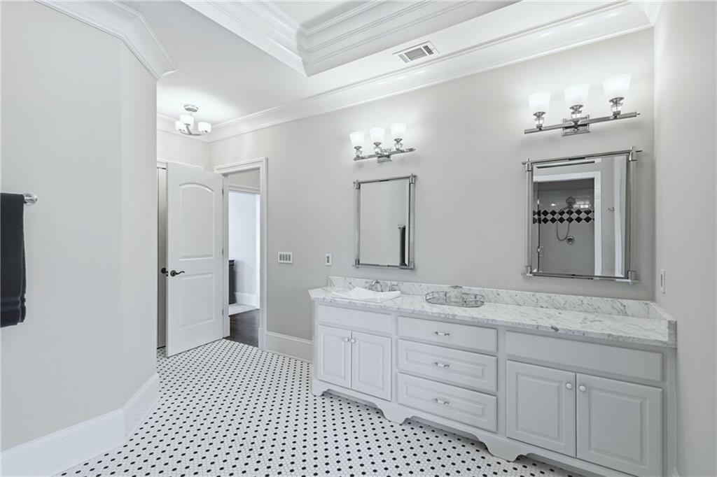 2957 Darlington Run Duluth, GA 30097 - Photo 47 of 58 a spacious bathroom with a granite countertop sink a mirror and a shower
