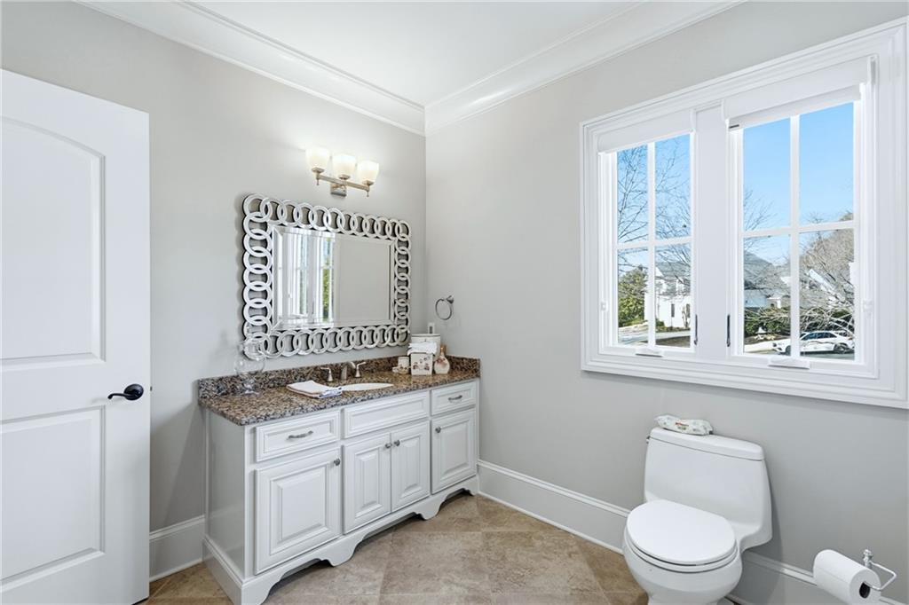 2957 Darlington Run Duluth, GA 30097 - Photo 50 of 58 a spacious bathroom with a granite countertop toilet a sink and a window
