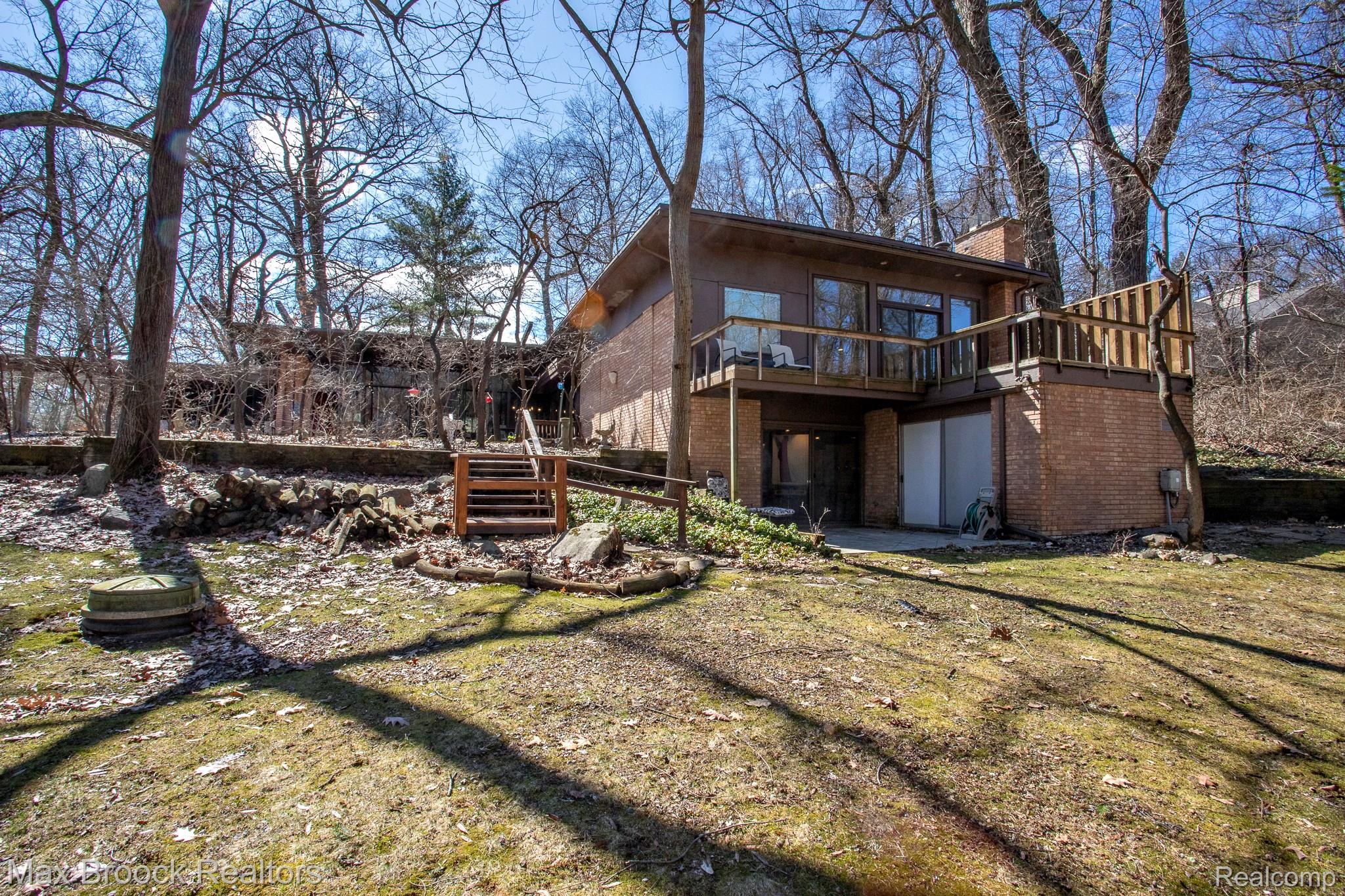 30875 Franklin Road Franklin, MI 48025 - Photo 72 of 86 Rear view of house featuring brick siding, a patio, a deck, and a yard