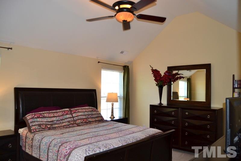 4235 Dalcross Road Raleigh, NC 27610 - Photo 13 of 25 a bedroom with a bed and a dresser