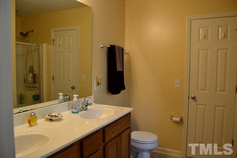 4235 Dalcross Road Raleigh, NC 27610 - Photo 15 of 25 a bathroom with a sink and a mirror