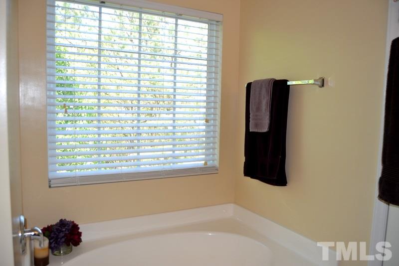 4235 Dalcross Road Raleigh, NC 27610 - Photo 16 of 25 a bathroom with a bathtub and a window