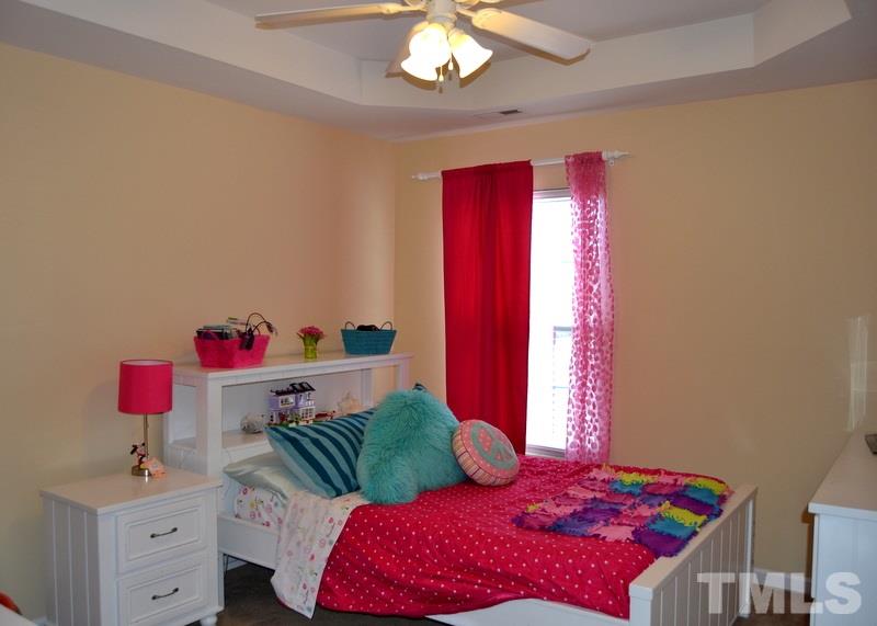 4235 Dalcross Road Raleigh, NC 27610 - Photo 17 of 25 a bedroom with a bed and a chandelier