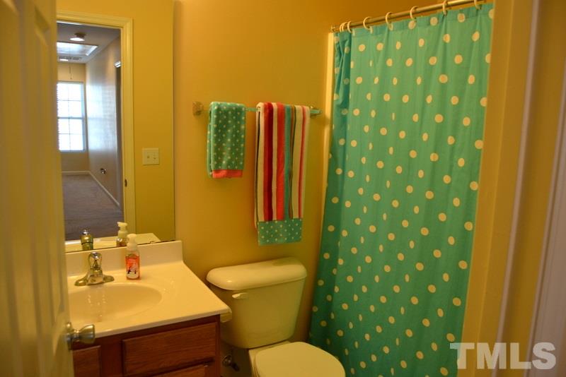 4235 Dalcross Road Raleigh, NC 27610 - Photo 19 of 25 a bathroom with a sink toilet and shower