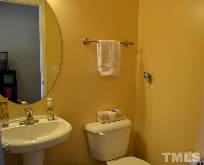 4235 Dalcross Road Raleigh, NC 27610 - Photo 5 of 25 a bathroom with a sink and mirror with toilet