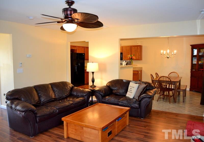 4235 Dalcross Road Raleigh, NC 27610 - Photo 25 of 25 a living room with furniture kitchen view and a wooden floor