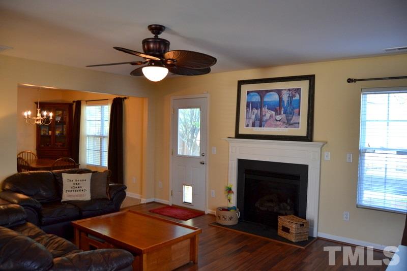 4235 Dalcross Road Raleigh, NC 27610 - Photo 7 of 25 a living room with furniture a window and a fireplace