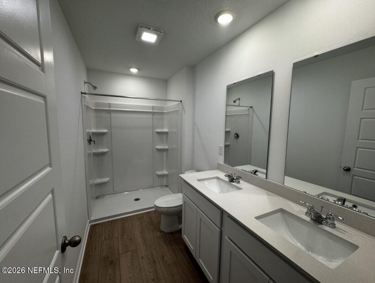 12343 Great Eagle Road Jacksonville, FL 32219 - Photo 7 of 44 a bathroom with a double vanity sink mirror double and shower