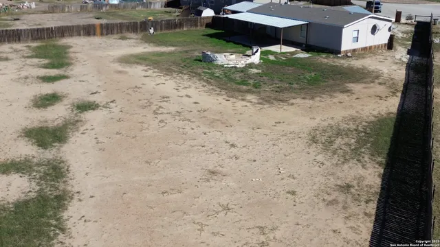 a backyard of a house with a yard and a fountain