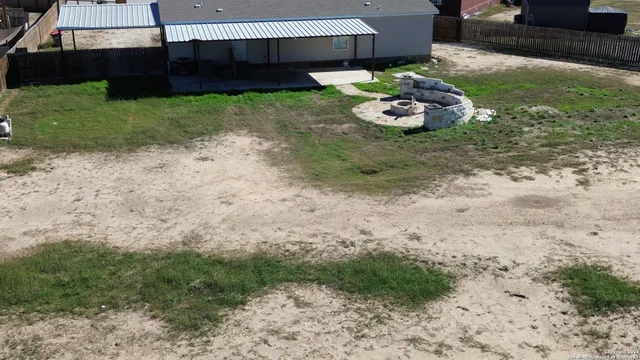 a backyard of a house with a yard and seating area