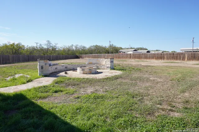 a view of a garden with an outdoor seating