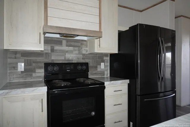 a kitchen with a refrigerator stove and cabinets