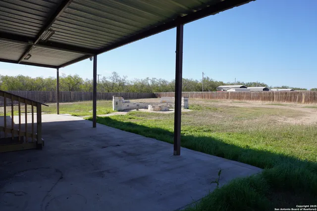 a view of a patio with a backyard