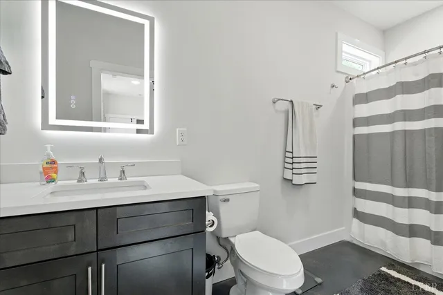 a view of an empty room with large windows